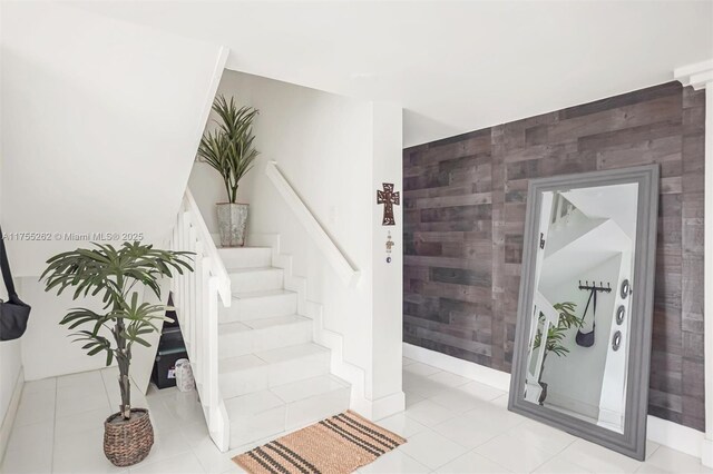 14421 SW 116th Ter, Miami, FL 33186 - staircase with tile walls, tile patterned floors, and an accent wall