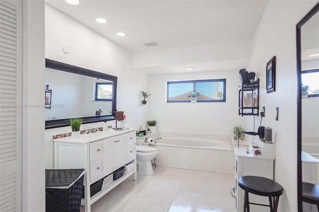 full bathroom featuring tile patterned flooring, toilet, a garden tub, recessed lighting, and vanity