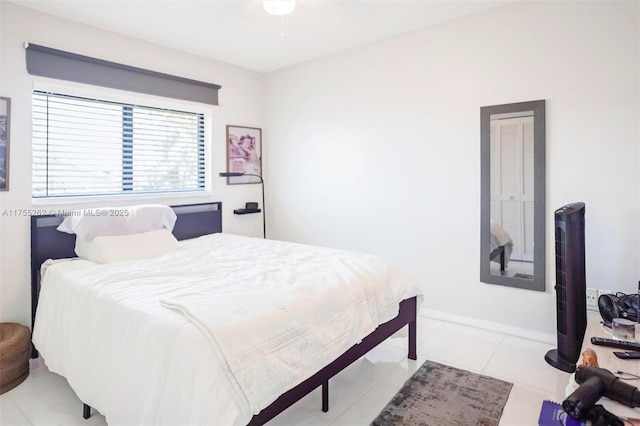 tiled bedroom featuring baseboards