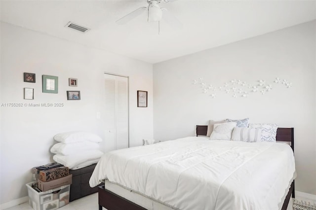 bedroom featuring baseboards, ceiling fan, visible vents, and a closet