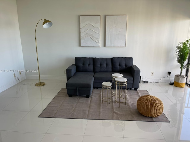 living room with tile patterned flooring and baseboards