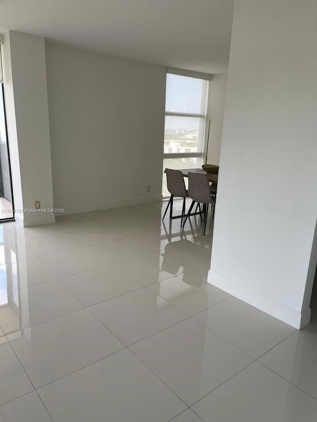 interior space with light tile patterned floors and baseboards