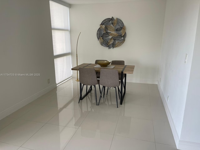 dining room featuring light tile patterned flooring and baseboards