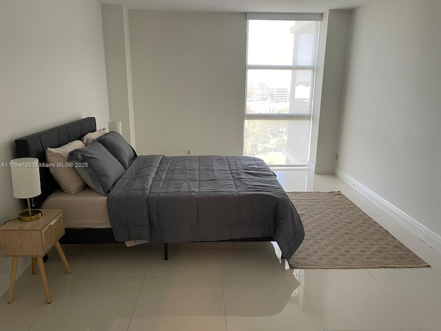 bedroom with tile patterned flooring and baseboards