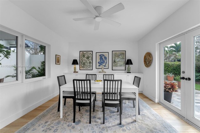 dining space with french doors, light wood finished floors, and baseboards