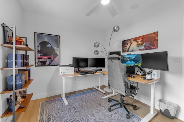 office area with ceiling fan, baseboards, and wood finished floors