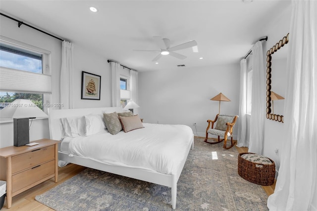 bedroom featuring ceiling fan, light wood finished floors, visible vents, and recessed lighting