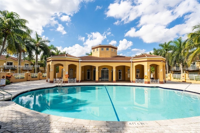 pool with fence and a patio