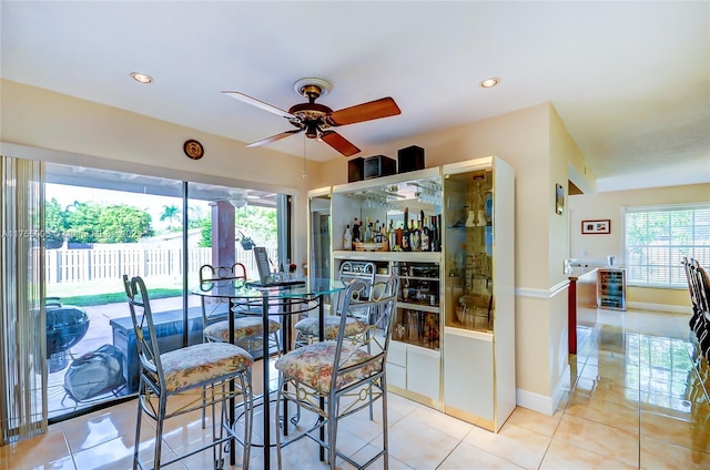 tiled dining room featuring baseboards, a ceiling fan, and recessed lighting