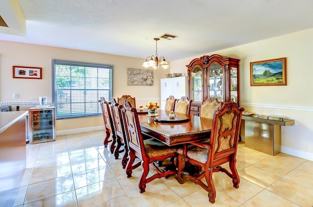 dining space featuring light tile patterned flooring, beverage cooler, visible vents, baseboards, and an inviting chandelier