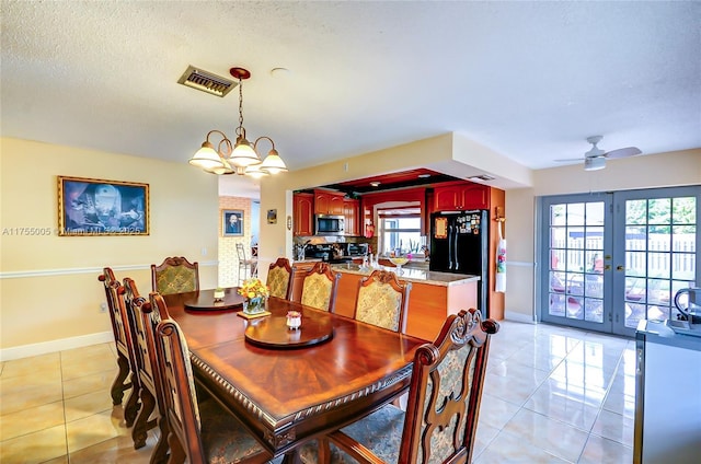 dining space featuring light tile patterned floors, baseboards, visible vents, a textured ceiling, and french doors