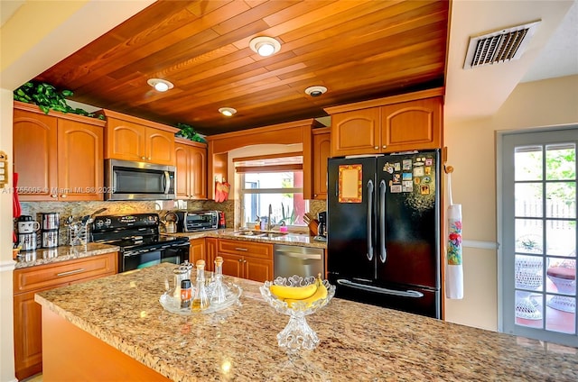 kitchen featuring tasteful backsplash, visible vents, a healthy amount of sunlight, wooden ceiling, and black appliances