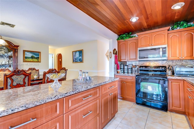 kitchen featuring light tile patterned floors, visible vents, decorative backsplash, stainless steel microwave, and black electric range oven