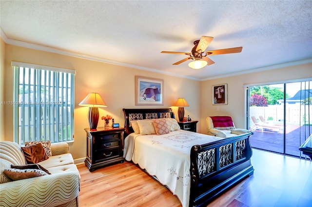 bedroom with ornamental molding, multiple windows, light wood-style flooring, and access to exterior