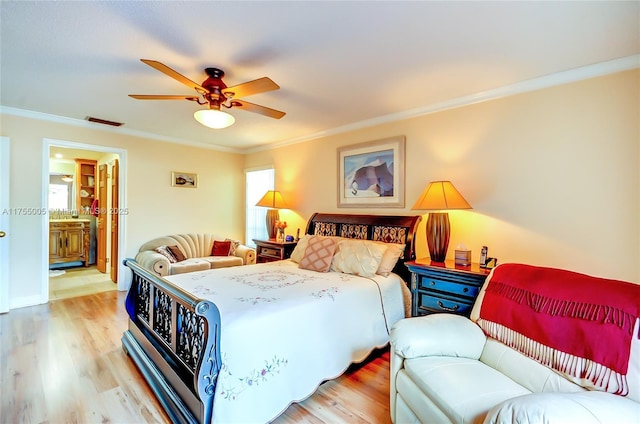 bedroom featuring light wood-style floors, multiple windows, visible vents, and crown molding