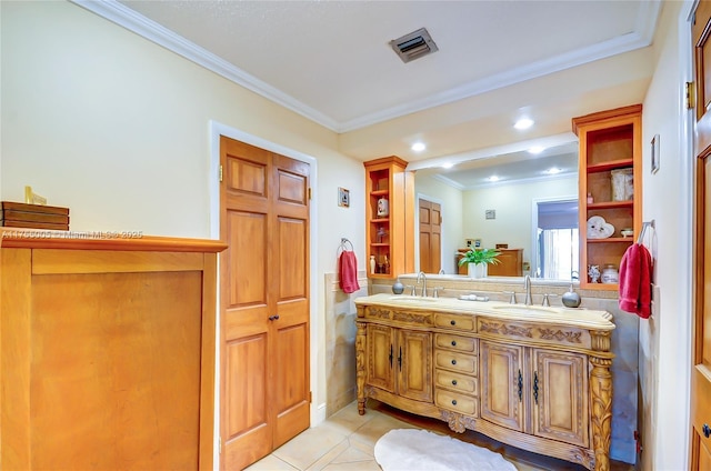 full bath featuring crown molding, double vanity, visible vents, a sink, and tile patterned floors