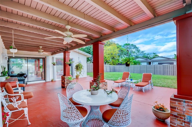 view of patio with fence private yard, outdoor dining area, and a ceiling fan