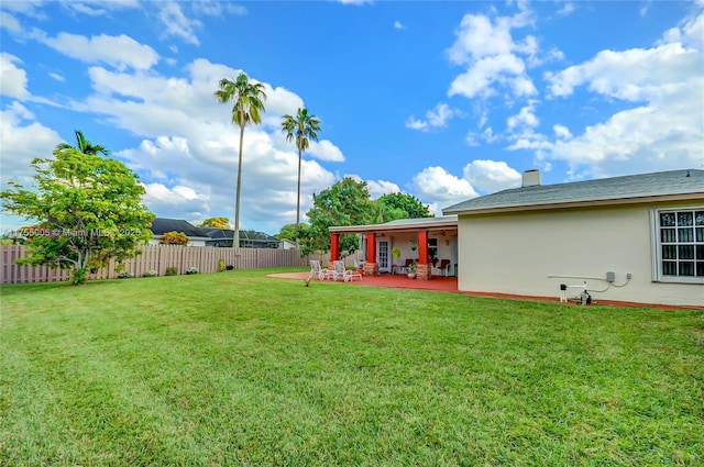 view of yard featuring fence and a patio