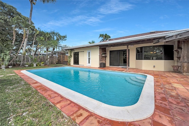 view of swimming pool with a patio area, fence, and a fenced in pool