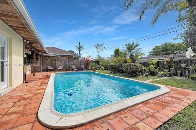 view of swimming pool featuring a patio area, a fenced backyard, and a fenced in pool