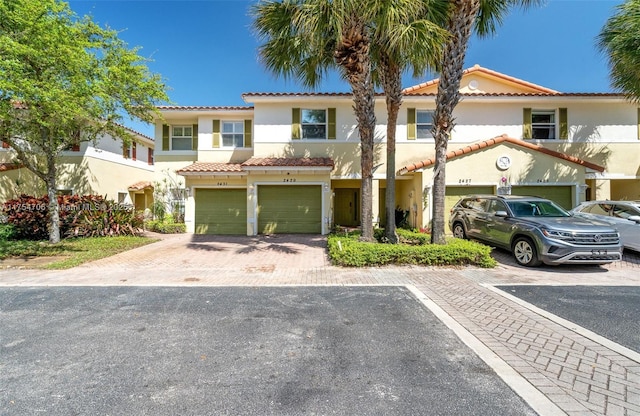 view of front facade featuring a garage, driveway, and stucco siding