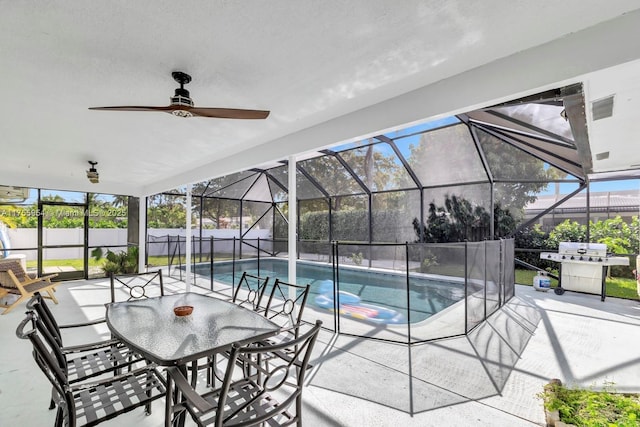 view of pool with a patio area, ceiling fan, glass enclosure, and a fenced in pool