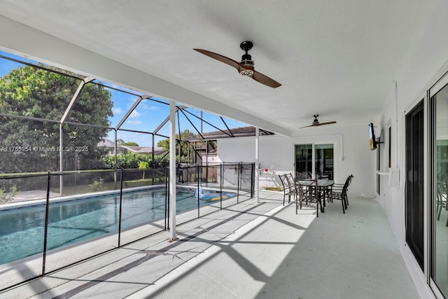 view of pool featuring a patio, a lanai, a ceiling fan, a fenced in pool, and outdoor dining space