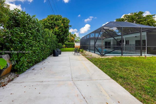 view of community featuring a yard, a swimming pool, and a patio