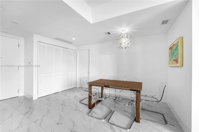 office area with marble finish floor, visible vents, and baseboards