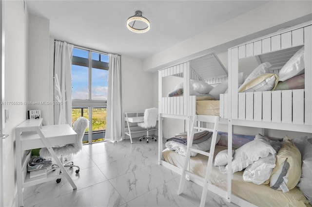 bedroom with expansive windows and marble finish floor