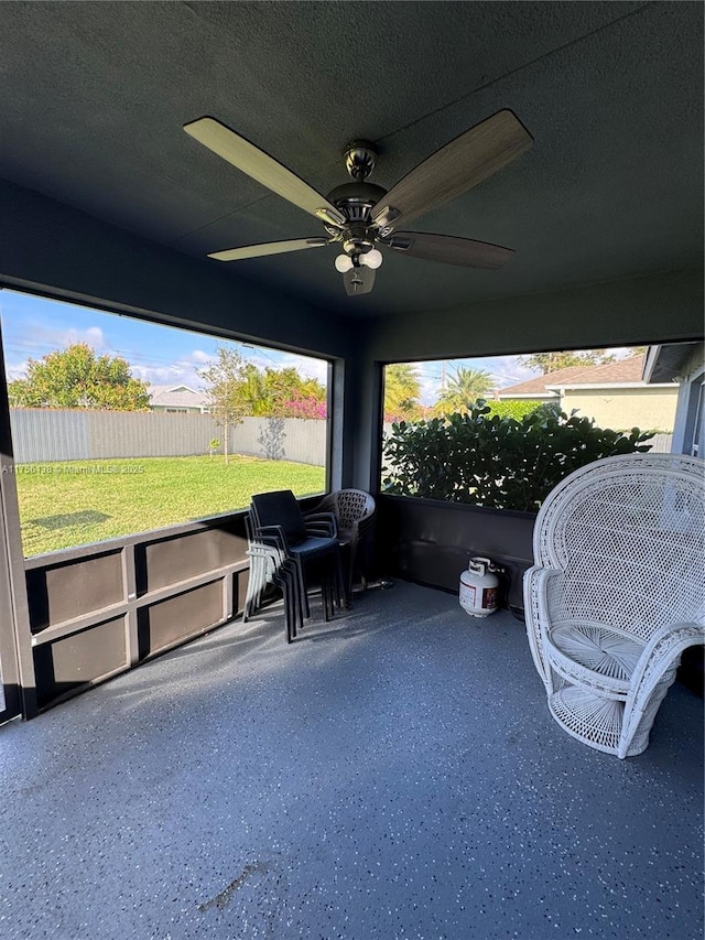 sunroom featuring ceiling fan and a wealth of natural light