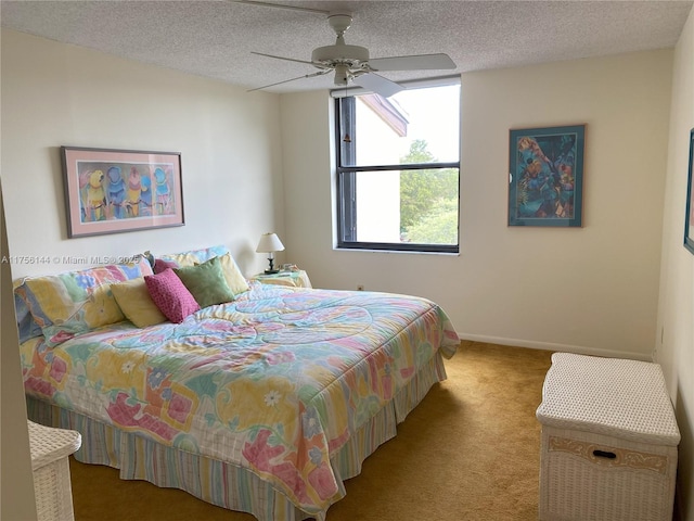 carpeted bedroom featuring ceiling fan, baseboards, and a textured ceiling