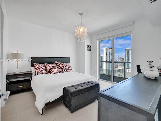 bedroom with a view of city, a notable chandelier, light tile patterned floors, visible vents, and access to outside