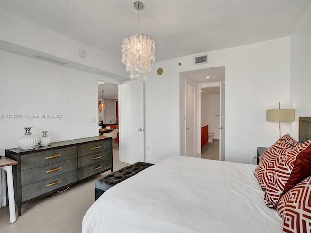 bedroom with visible vents and an inviting chandelier