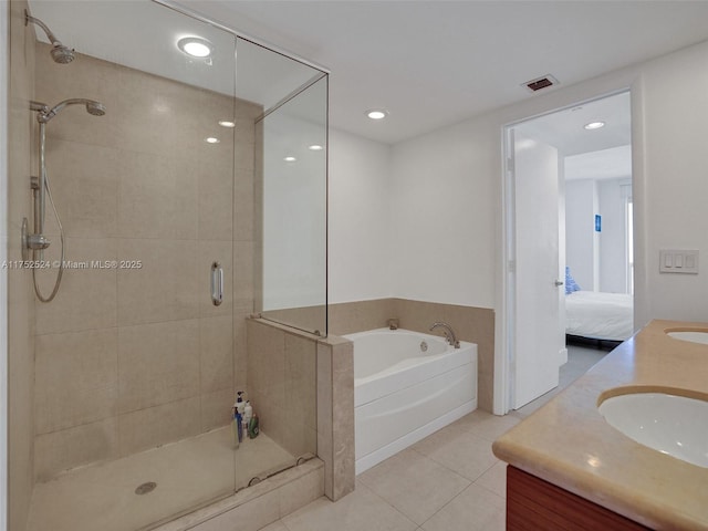 ensuite bathroom with a stall shower, a sink, ensuite bath, tile patterned flooring, and a bath