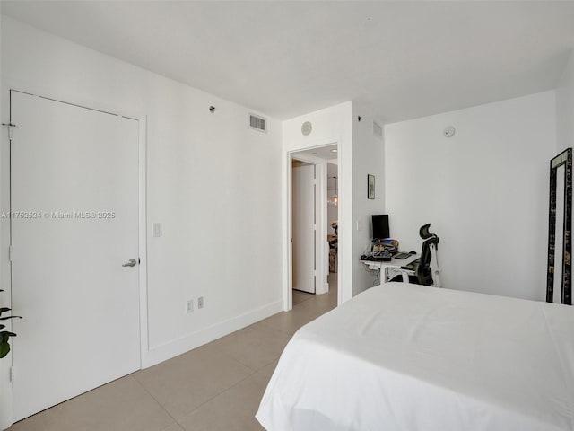 bedroom with light tile patterned floors, baseboards, and visible vents