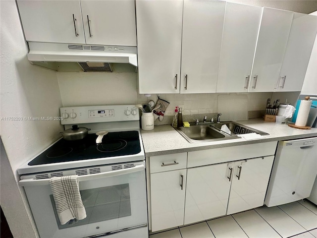 kitchen with light countertops, white appliances, a sink, and under cabinet range hood