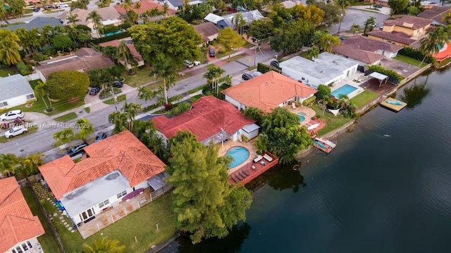 birds eye view of property with a water view and a residential view