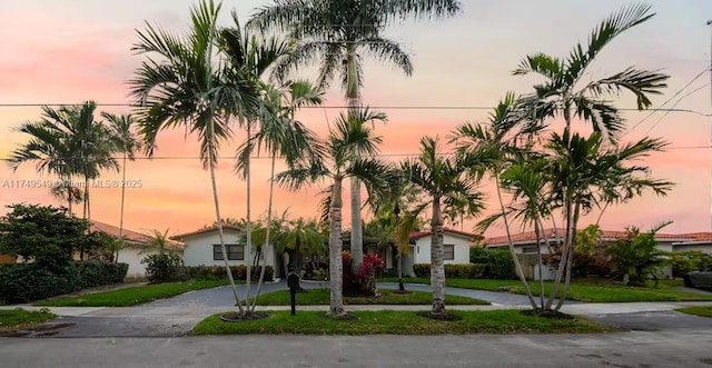 property at dusk with driveway