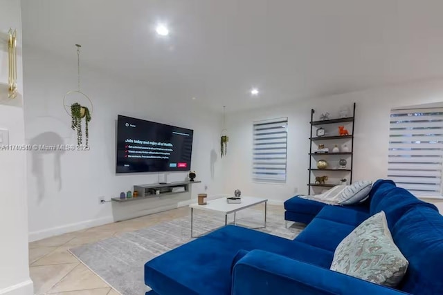 living room featuring recessed lighting, tile patterned flooring, and baseboards