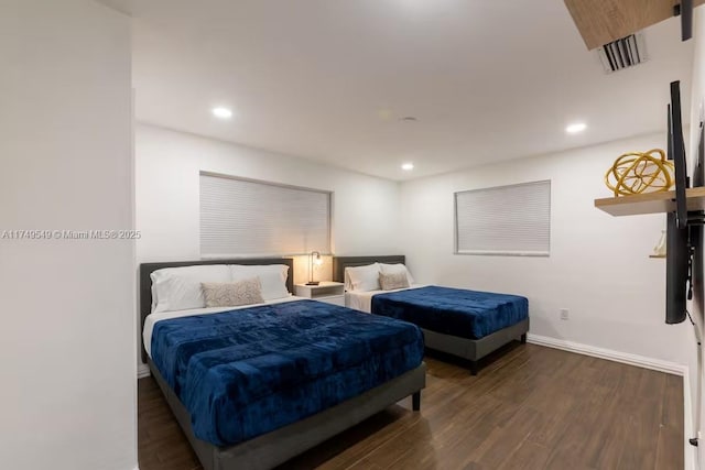 bedroom with recessed lighting, wood finished floors, and baseboards