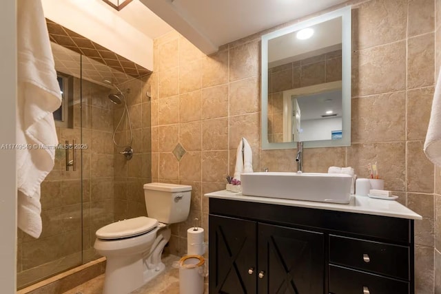 bathroom featuring toilet, a stall shower, and tile walls