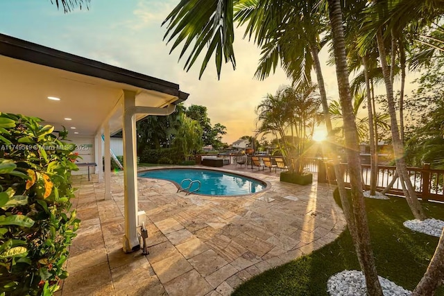 outdoor pool with a patio area