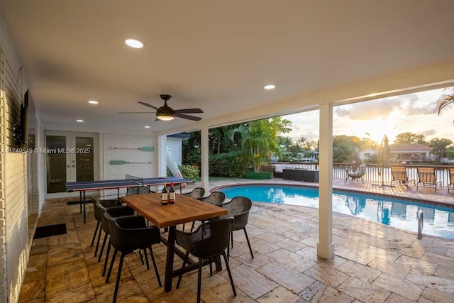 view of swimming pool featuring ceiling fan, french doors, a patio area, and a fenced in pool