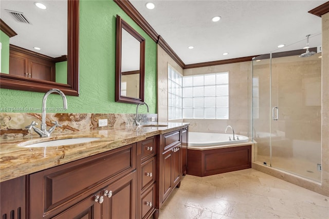 full bath featuring a garden tub, a shower stall, crown molding, and a sink