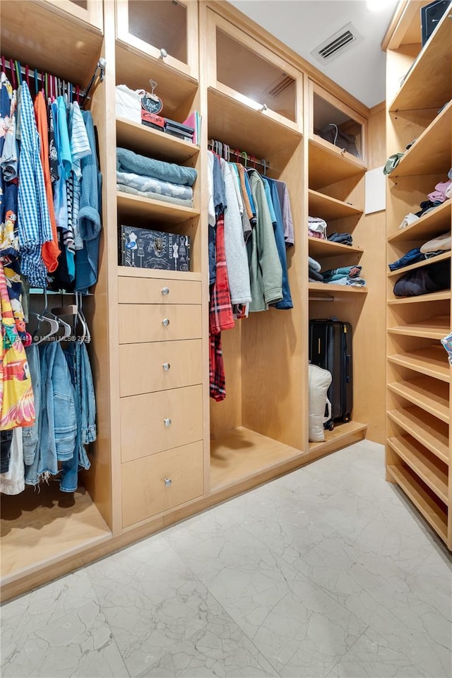 spacious closet with marble finish floor and visible vents