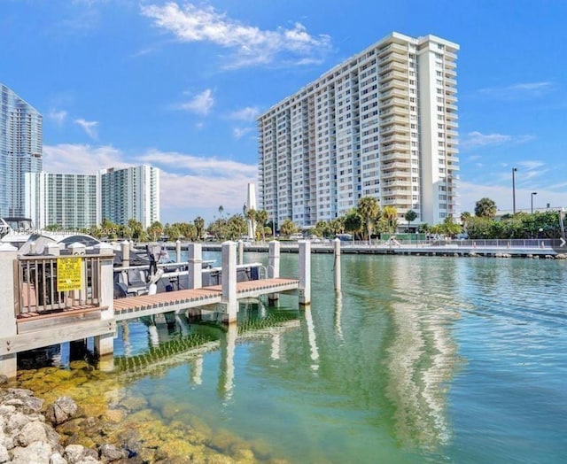 view of dock featuring a water view and a city view