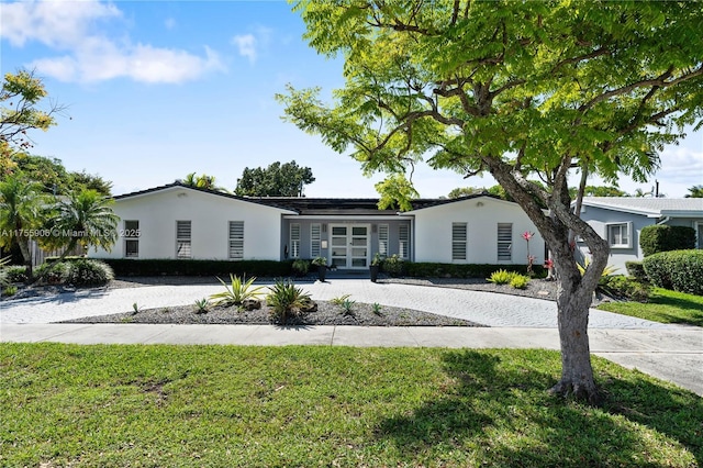 view of front of house featuring a front yard and stucco siding