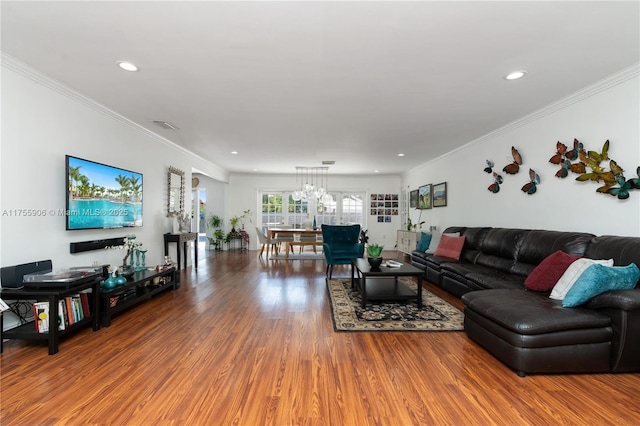 living room featuring ornamental molding, recessed lighting, and wood finished floors