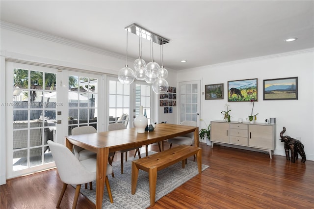 dining area featuring crown molding, wood finished floors, and french doors